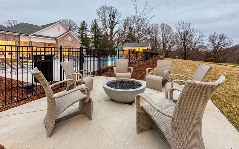 Large fire pit located next to the pool 